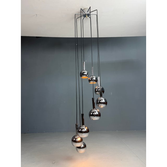 Stunning Space Age cascading ceiling lamp from the 1970s, featuring 8 metal shades in a sleek, futuristic design. This...