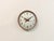 This wall clock was produced by Westclocx in Canada during the 1960s. It features a brown iron frame, a metal dial and a...