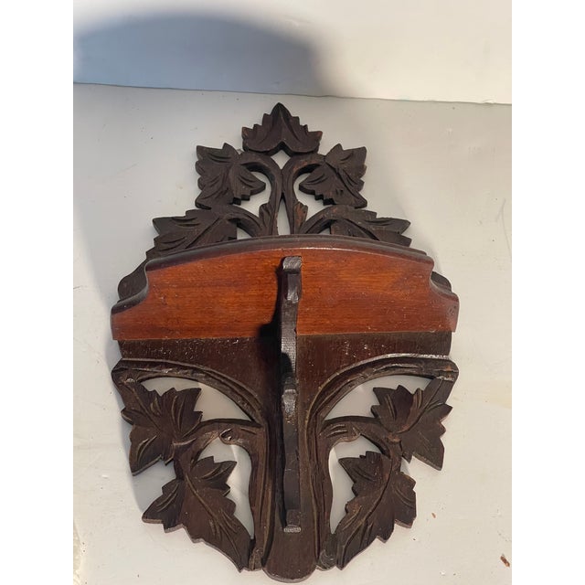 Beautifully carved wood antique decorative wall shelf in Black Forest style.