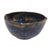 A gorgeous studio pottery bowl, hand-thrown and artist signed, with rich layers of blue, purple, and gold glaze pooling in...