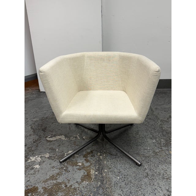 Design Plus Gallery presents the Swivel Facetta Chair from CB2. This contemporary accent chair is upholstered in an ivory-...
