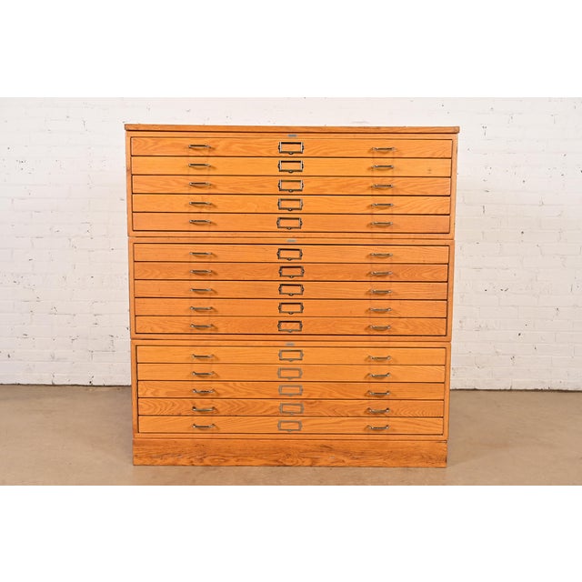 An exceptional vintage Mid-Century Modern or Arts & Crafts style oak 15-drawer architect's blueprint flat file cabinet,...