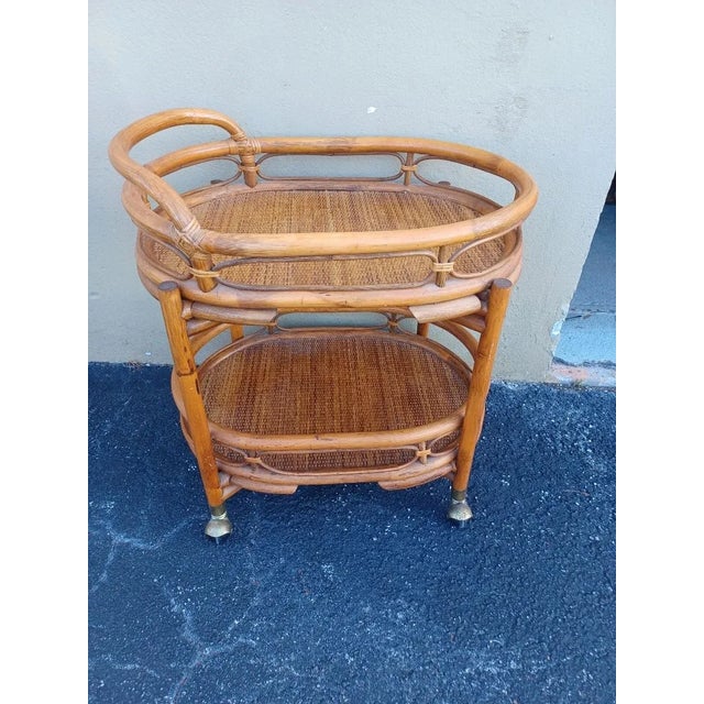 Vintage Bamboo and raffia bar cart on casters. Top of bar is a removable tray that is easily removed.