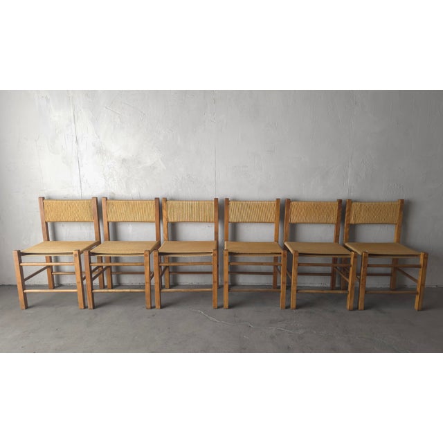 Vintage Set of 6 Rustic Danish European Oak and Rope Dining Chairs. The chairs feature solid wood frames with large...