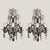Pair of crystal and bronze wall sconces, France circa 1900s. The French sconces have a bronze frame with a Lyre shape. The...