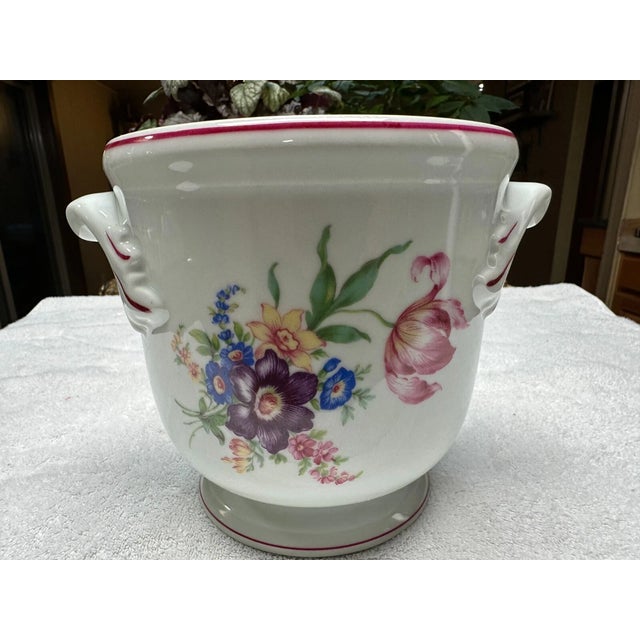 Indulge in pure Portuguese elegance with this breathtaking Vista Alegre cachepot, a true masterpiece of luxury porcelain...