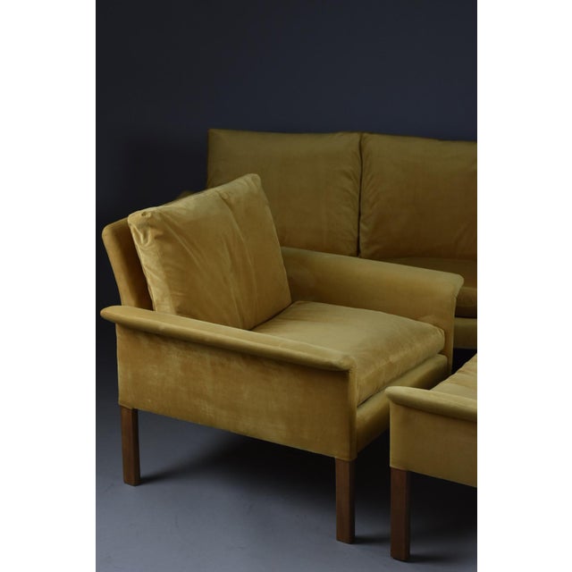 A rare and iconic lounge set designed by hans olsen in the 1960s, composed of a three-seater sofa, armchair, and ottoman....