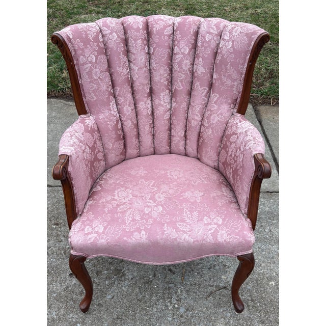 A beautiful pink floral damask fabric chair with channel back tufting and Queen Anne front legs. The pretty pink hue leans...