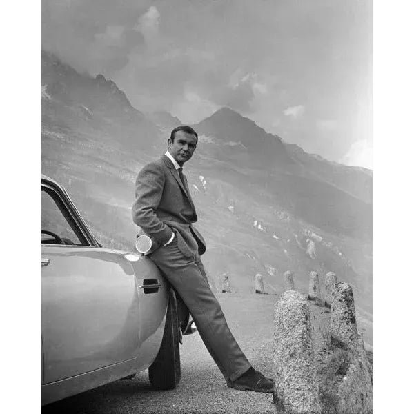 Sean Connery was the first James Bond (and perhaps the best). Our beloved 007 is pictured here with his Aston Martin DB-5....