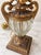 Elegant Antique table lamp featuring an elaborate textile shade in warm beige and burgundy tones, richly decorated with...