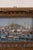 Antique French oil on board depicting boats in a harbor. Presented in a carved wood frame with gilt finish.