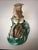A beautifully detailed Chinese famille rose porcelain figural sculpture featuring a traditionally dressed figure...
