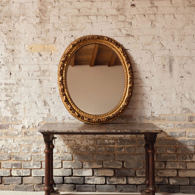 Add refined decorative elegance to your space with this 19th century French round wooden mirror, a beautifully crafted...