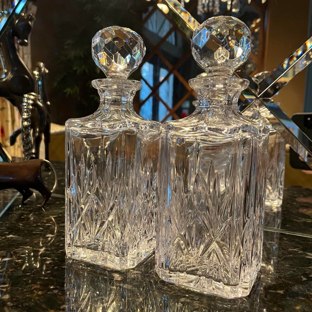 Pair of vintage Tiffany & Co. crystal decanters. Beautiful heavy cut crystal with classic starburst pattern and faceted...