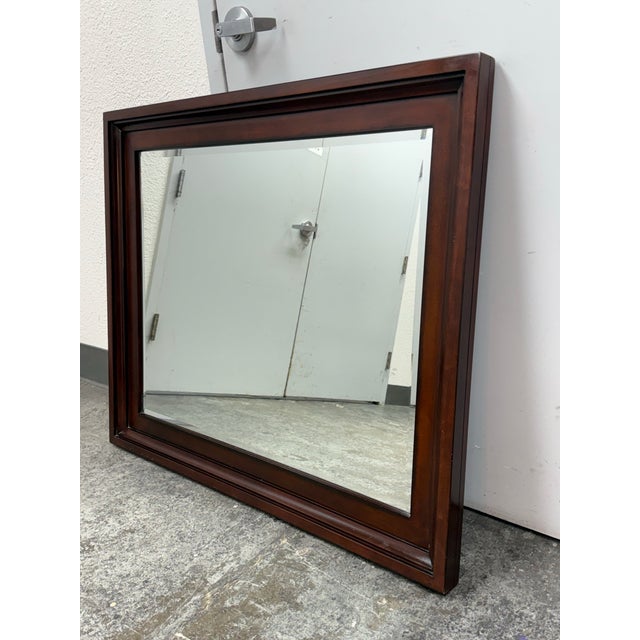 Design Plus Gallery presents a Cherry Wood Wall Mirror from Omexey Home Furnishings. The rectangular mirror has a broad...