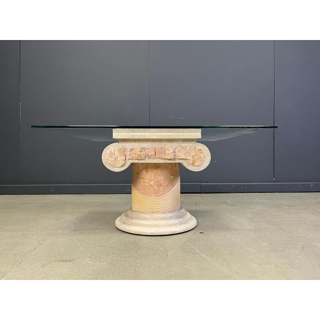 Elegant tesselated stone coffee table pedestal base with a square clear glass top. The coffee table has a lot of cool...