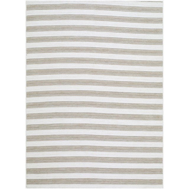 Transform your outdoor space into a coastal haven with the Patio Plus area rug, where traditional style meets modern...