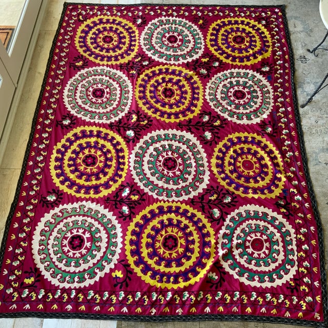 Antique gorgeous large scale suzani in vibrant hues of raspberry red, teal green, white, yellow and black. Suzani measures...