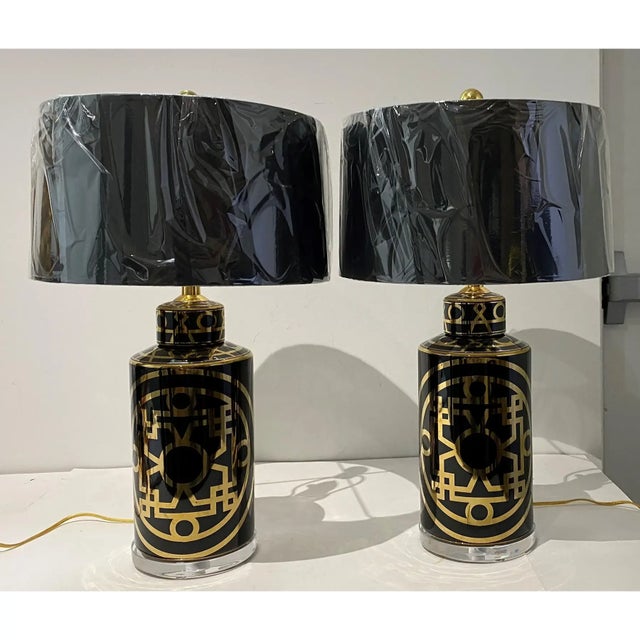 (NOTE- shades not included) Chic pair of black ceramic porcelain and Lucite table lamps, Mid-Century Modern with abstract...