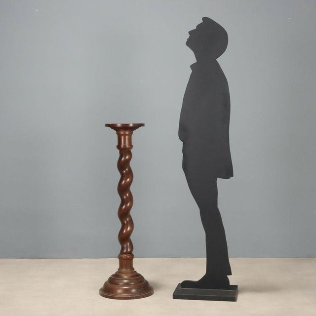 Walnut pedestal plant stand from the late 19th century, originating from Italy, featuring an elegant and functional...