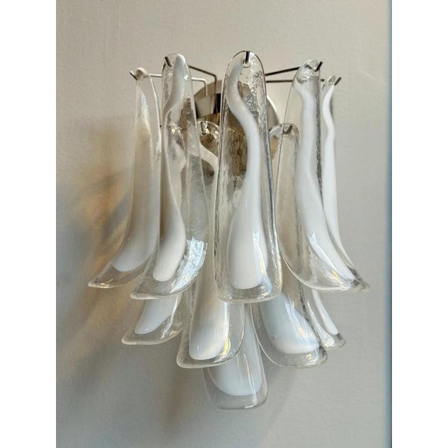 Pair of white murano wall lamps consisting of ten glass prisms in white and clear glass with lamp bases finishes and...
