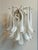 Pair of white murano wall lamps consisting of ten glass prisms in white and clear glass with lamp bases finishes and...