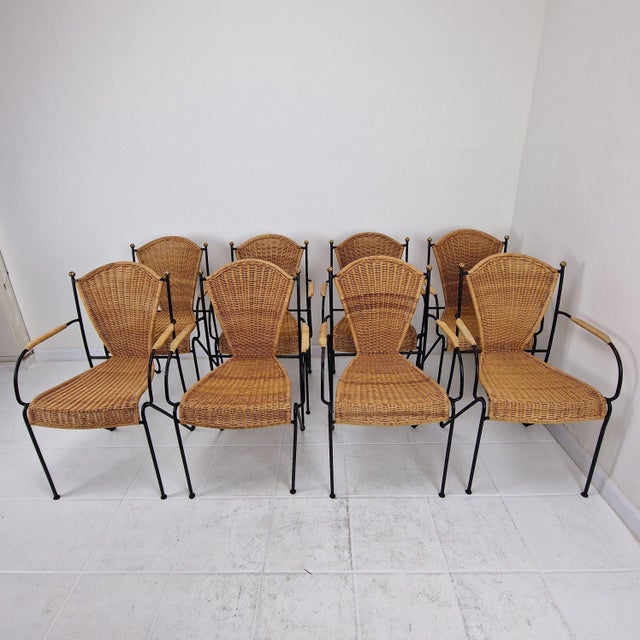 The chairs feature beautifully woven wicker seats and backs, set within a strong and sculptural black iron frame. The...