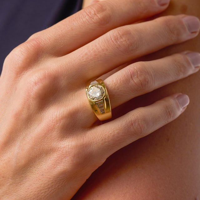 This bold vintage engagement ring showcases a striking 2.43 carat round brilliant cut diamond, certified by GIA...