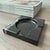 Handcrafted from richly veined black marble, the Naya Ashtray is defined by its clean square silhouette, recessed circular...