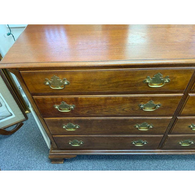 20th century Kindel cherry chest of drawers. Eight drawers run smoothly plinth base metal hardware, finish is in need of...