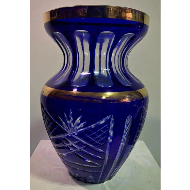 Bohemian carved glass vase in blue and golden tonality. This piece is attributed to the mentioned designer/maker. It has...