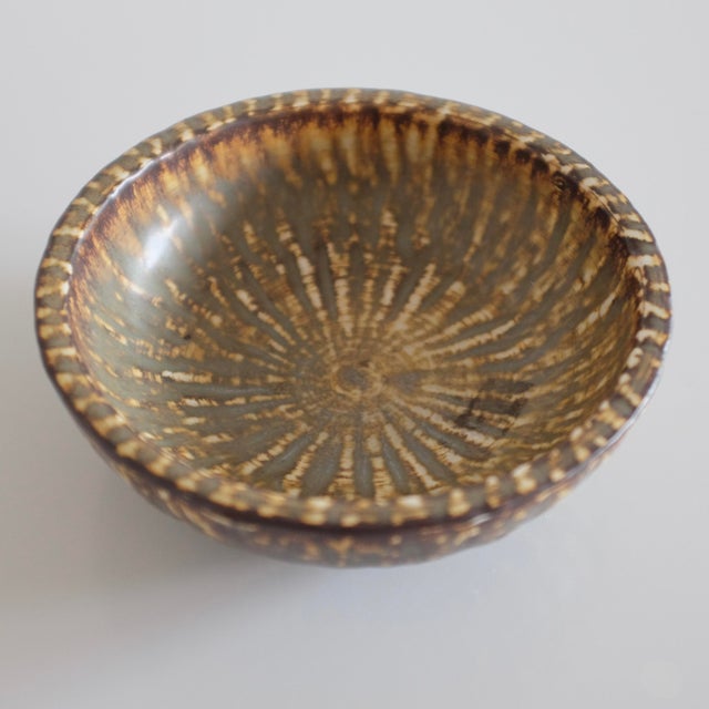 Small ceramic bowl from the Rubus collection by Gunnar Nylund for Rörstrand, Sweden. Decorative flame like design in...