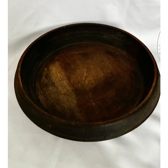 A generously proportioned antique wooden treen bowl, likely British and dating to the 19th century. Turned from a single...