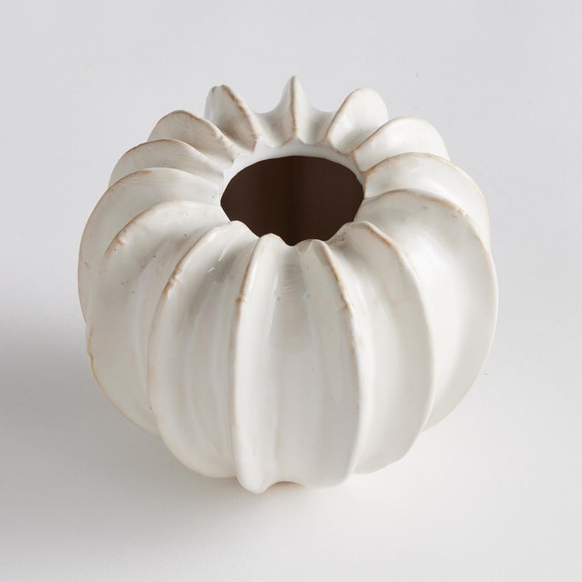 With a sculpted body and thickly applied glaze, this coastalinspired low bowl is a work of art. The handfinished details...