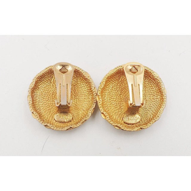 This is part of Chairish’s Costume Jewelry assortment. 1980s goldtone woven round clip back earrings. Marked "Escada."...