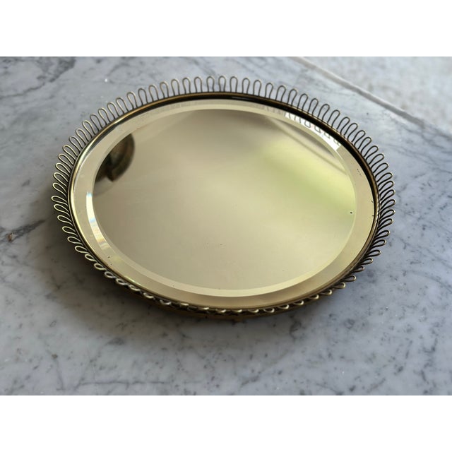 This elegant round mirror was designed by Josef Frank for Svenskt Tenn in Sweden during the 1950s. Crafted in solid brass,...
