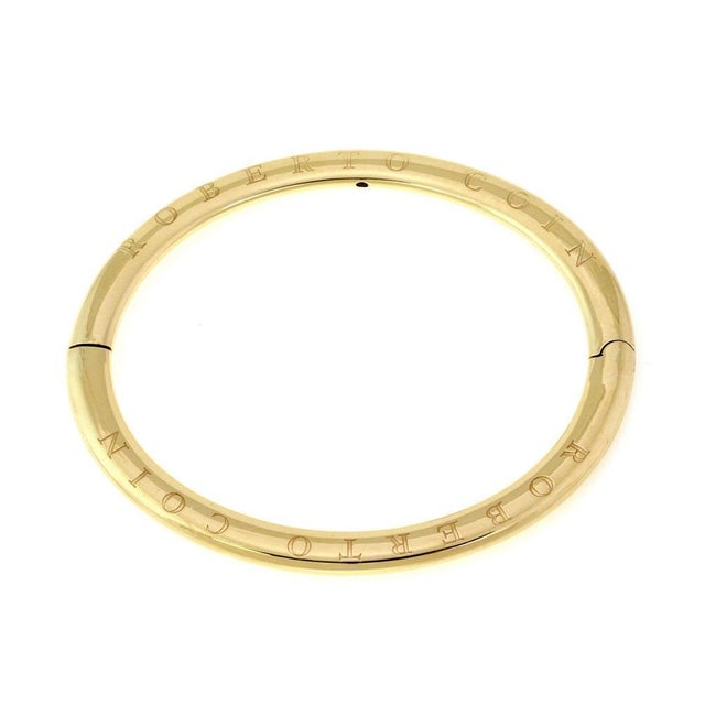 This is an authentic oval hinged bangle from Roberto Coin. It has 6mm wide flat form engraved Roberto Coin on both flat...