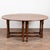 20th century English oak wake table featuring a classic drop-leaf gateleg design. The table is constructed with four gate...