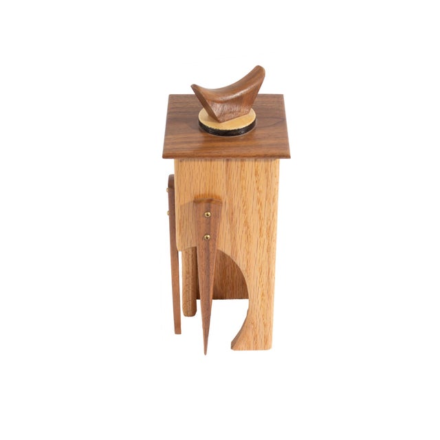 A 2006 hand-crafted wooden box. Signed and dated to the underside, the box is made from a variety of woods and has a lid...