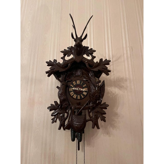 Architecturally styled case, with twisted columns on the uprights and capitals, and carved plant decorations on the top....