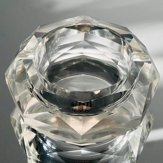 Mid-Century Modern cut crystal ashtray with faceted design. The ashtray is a round octagon in form creating prisms of...