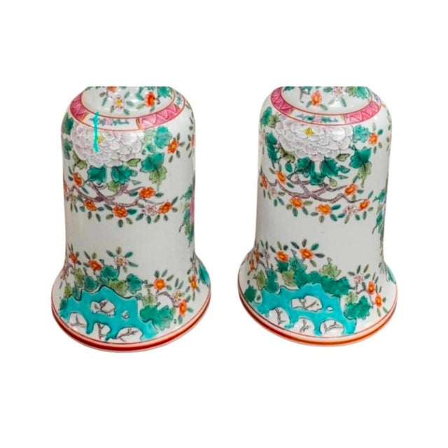 A rare pair of antique Chinese porcelain candlesticks, featuring a combination of famille verte and famille rose hand-...