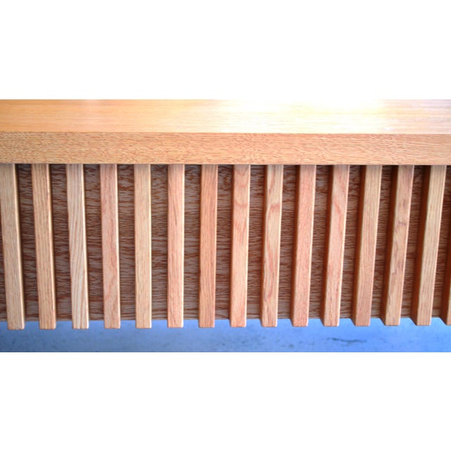 Simple one door three compartment media sideboard. Clear lacquered oak Class Low Base Unit Dimensions : 61" L x 22" D x...