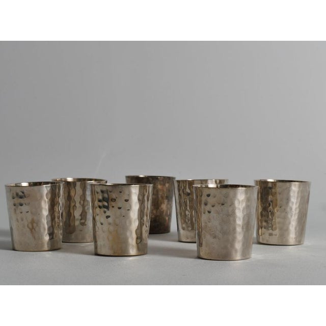 A handsome set of seven vintage silver-plated shot cups or schnapps tumblers featuring an all-over hand-hammered (martelé)...