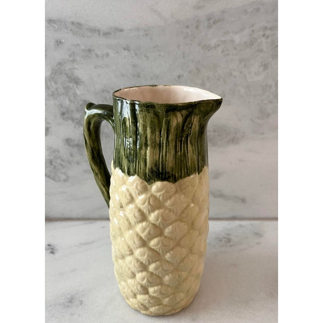 Vintage handmade ceramic pineapple pitcher with a handle. Hand painted in subtle yellow and green tones. Perfect for your...