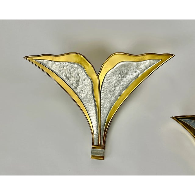 A beautiful pair of leaf wall lamps in gold and silver handcrafted hammered brass designed by Henri Fernandez for Maison...