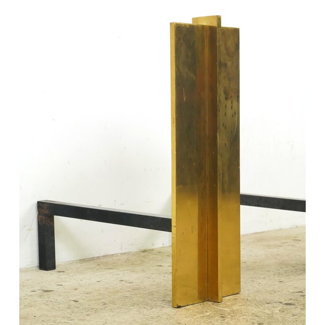Mid Century style andirons made of tall brass rectangular panels with cast iron supports. Andirons, also known as...