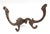 Victorian style hall tree hook made of cast iron with a dark brass finish. There is a screw attached to the back with a...
