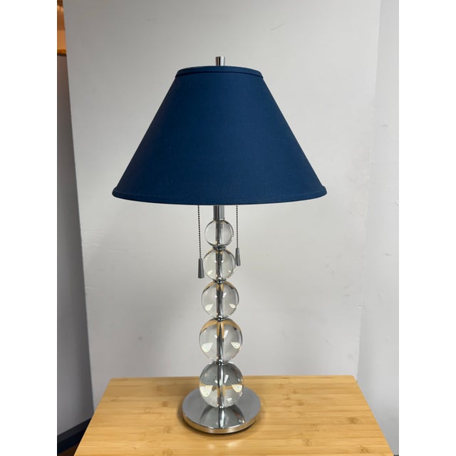 Design Plus Gallery presents a Modern Stacked Glass Orb Table Lamp. This contemporary lamp showcases five graduated...