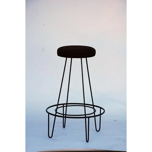 Pair of minimalistic bar stools with brown suede seats. Perfect for a modern home.
